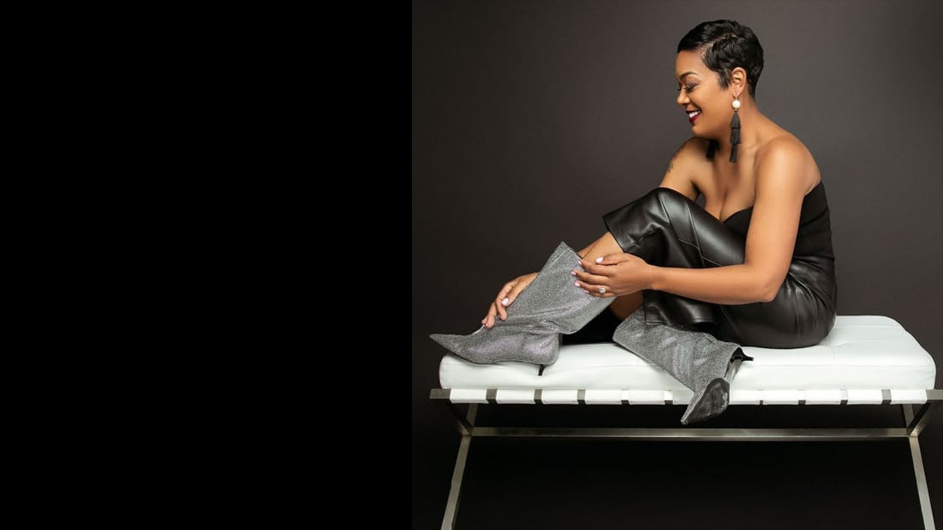 Maisha Bahati seated in a black look with statement boots